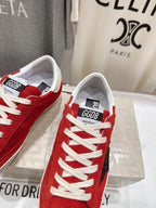 Golden Goose red sneakers close-up of tongue labels, white laces and white sole