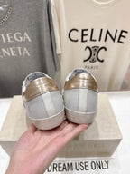 Golden Goose luxury sneakers: white sneakers with gold heel backs, view from the rear