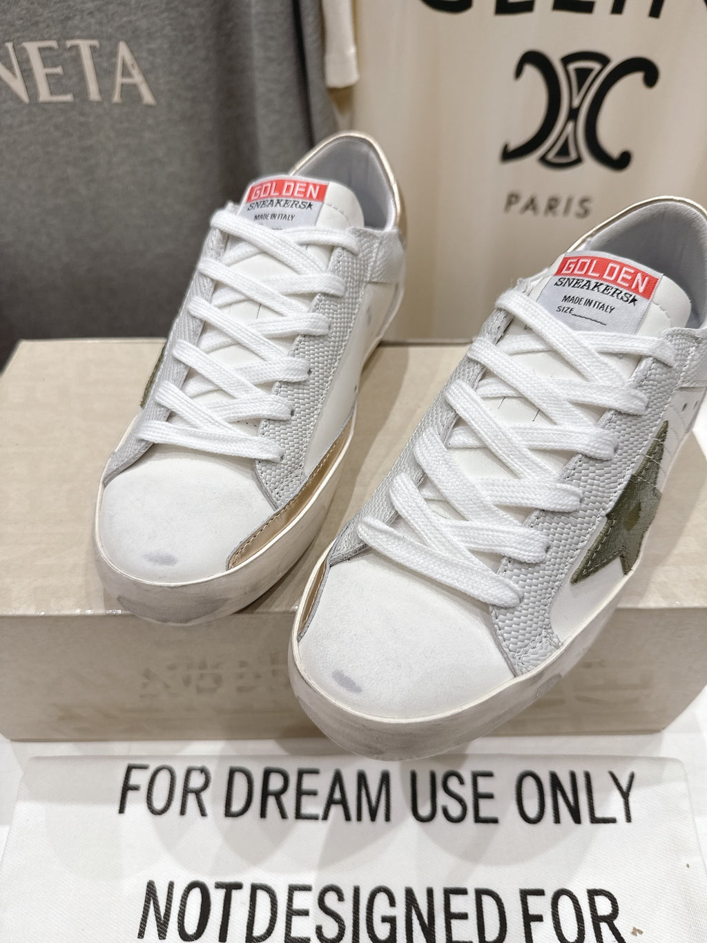 Golden Goose luxury sneakers: white low-top sneakers with green star side patch and gold tab