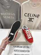 Golden Goose red sneakers with black textured outsole, shoe sole view