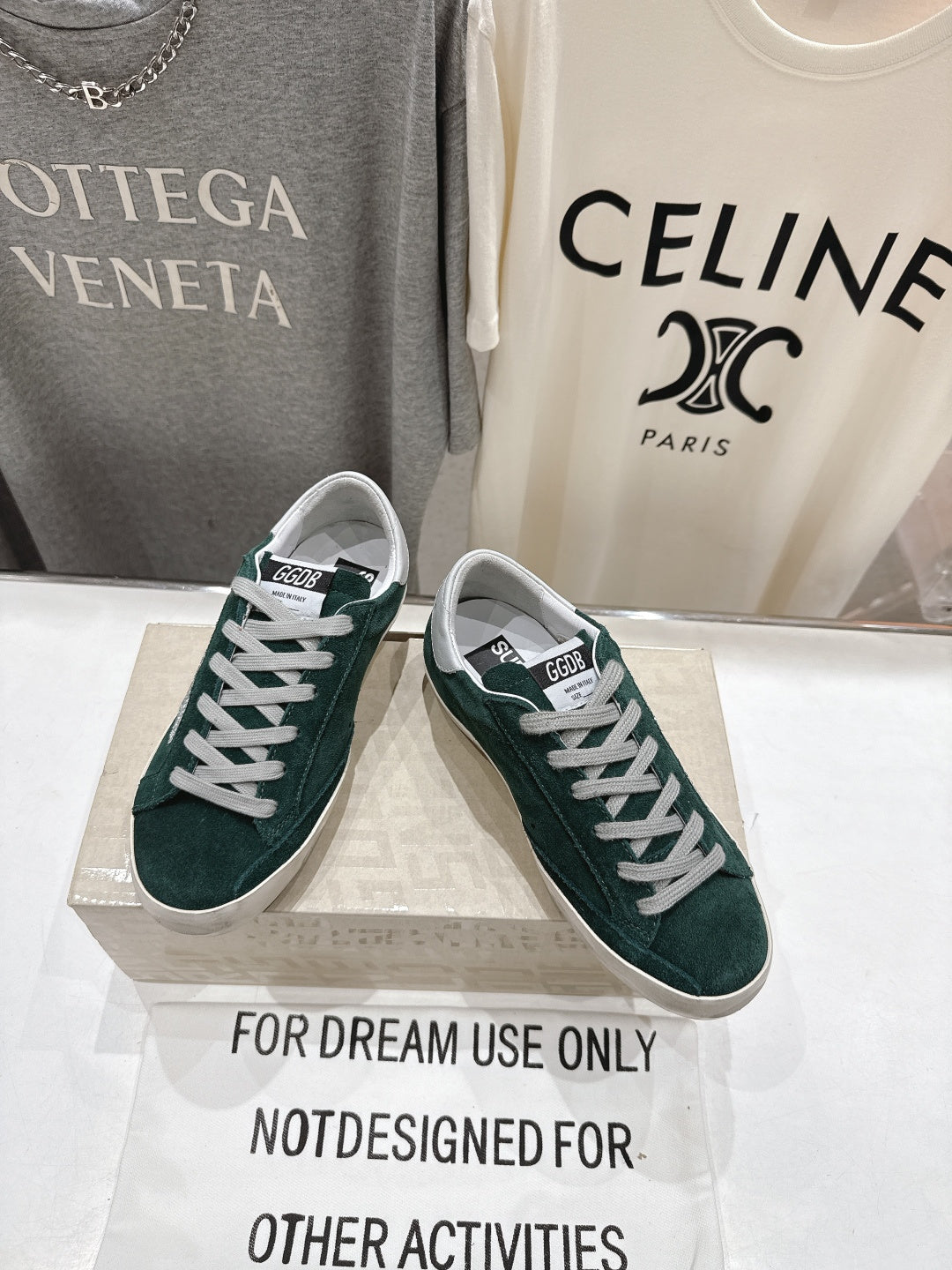 Dark green suede Golden Goose sneakers with white laces and thick white rubber sole