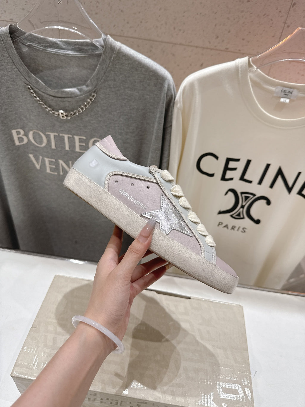 Lilac and white lace-up sneakers, close-up side with star detail and textured upper