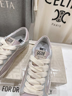 Lilac and white lace-up sneakers with logo patch, front view close-up pair
