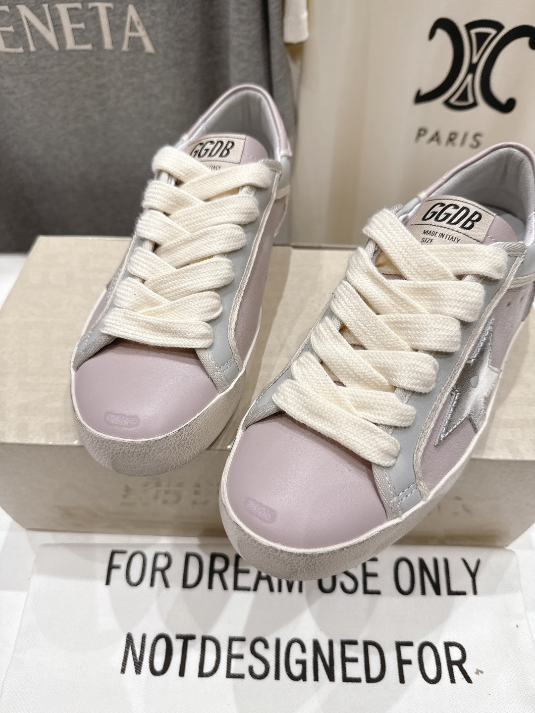 Lilac and white lace-up sneakers with star detail, front view pair on box