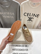 Tan sneaker outsole with textured traction pattern, white sole edge