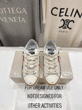 White low-top sneakers with lace-up front, printed logo tongue, and tan gum sole