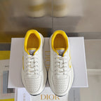 Dior unisex sneakers pair on box, white with yellow interiors and lace-up