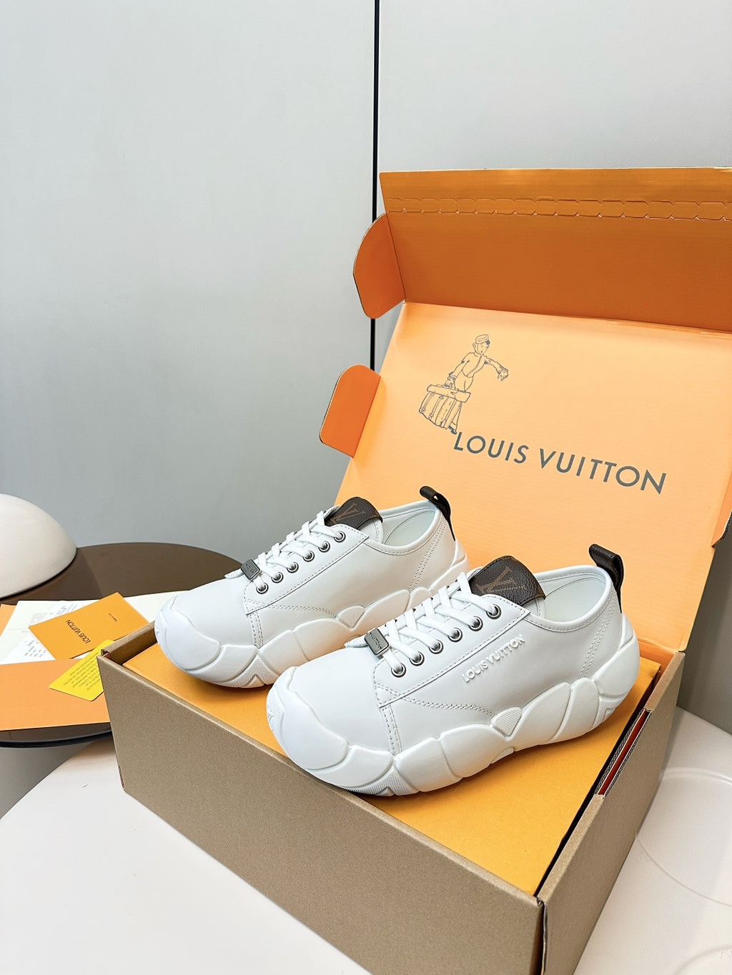 White lace-up sneakers with dark heel accents and textured rubber sole