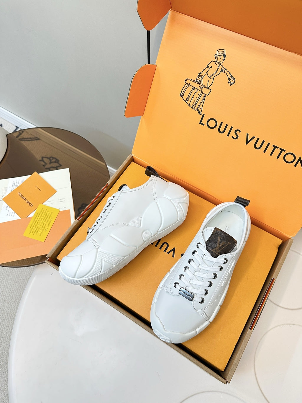 White lace-up sneakers with dark heel patch and embossed-style side panel