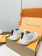 White low-top lace-up sneakers with dark heel tabs and padded chunky sole