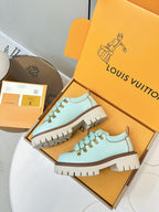 Louis Vuitton light blue lace-up sneakers with chunky brown sole and gold eyelets