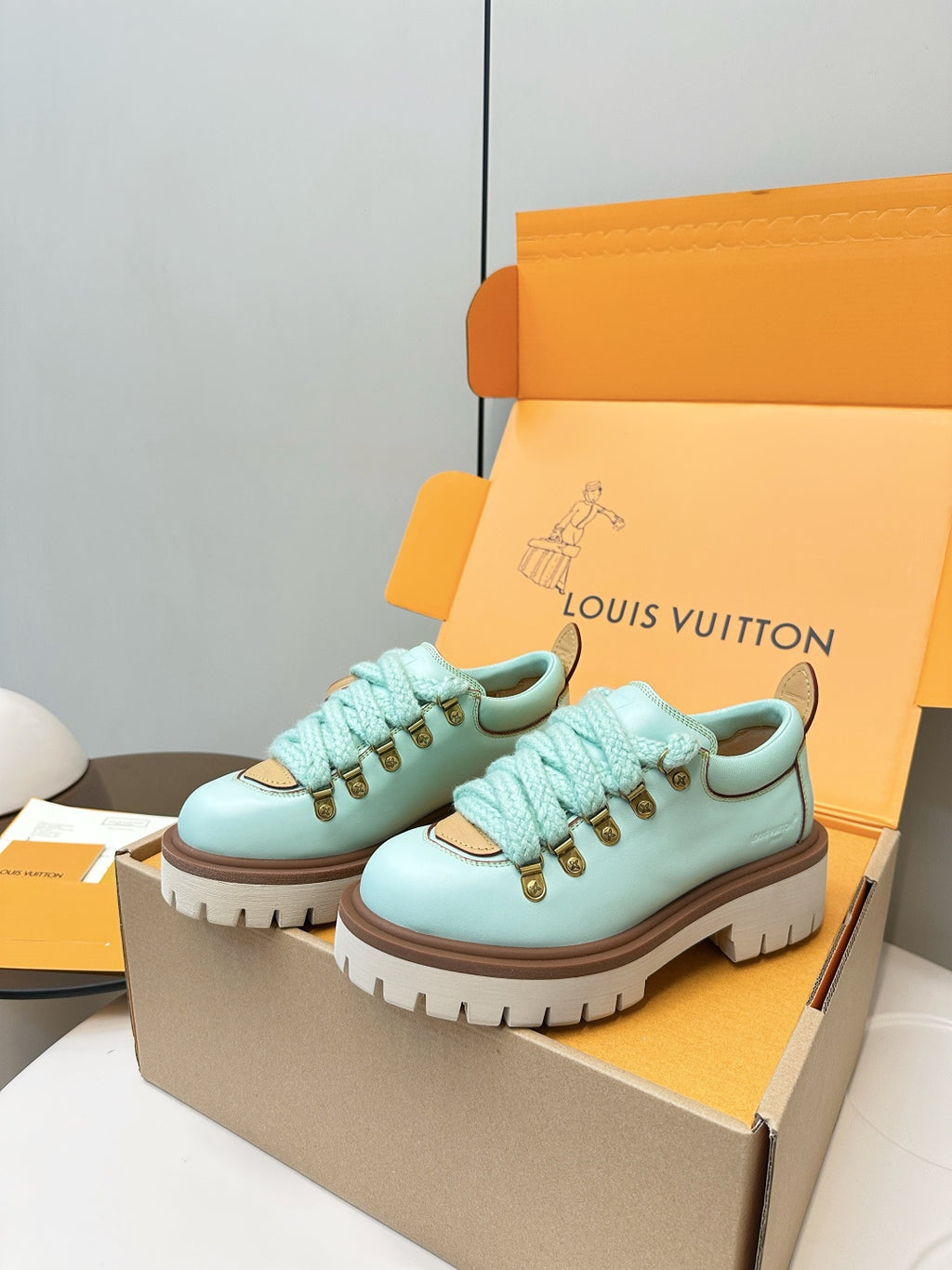 Louis Vuitton light blue lace-up sneakers with gold eyelets and monogram side patch