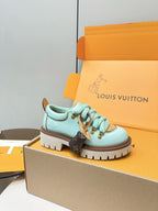 Louis Vuitton light blue lace-up sneaker with gold hardware and brown sole