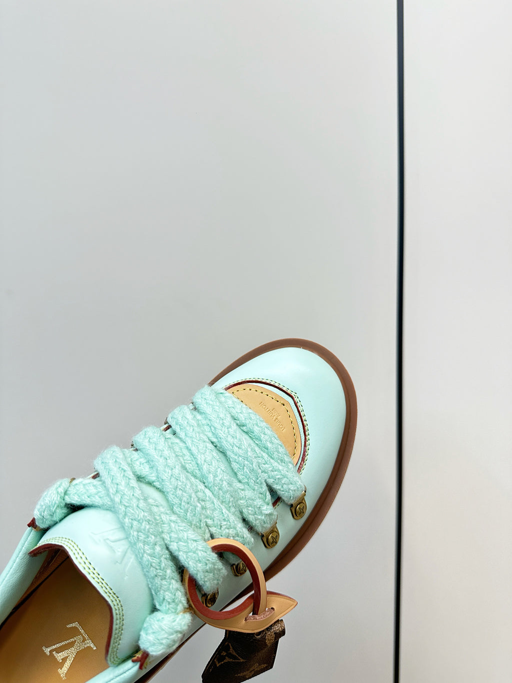 Louis Vuitton light blue sneaker with textured laces and gold lace hardware