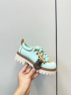 Louis Vuitton light blue lace-up sneaker with gold eyelets and brown-trimmed sole