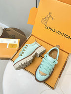 Louis Vuitton light blue sneakers with gold lace eyelets and brown outsole tread