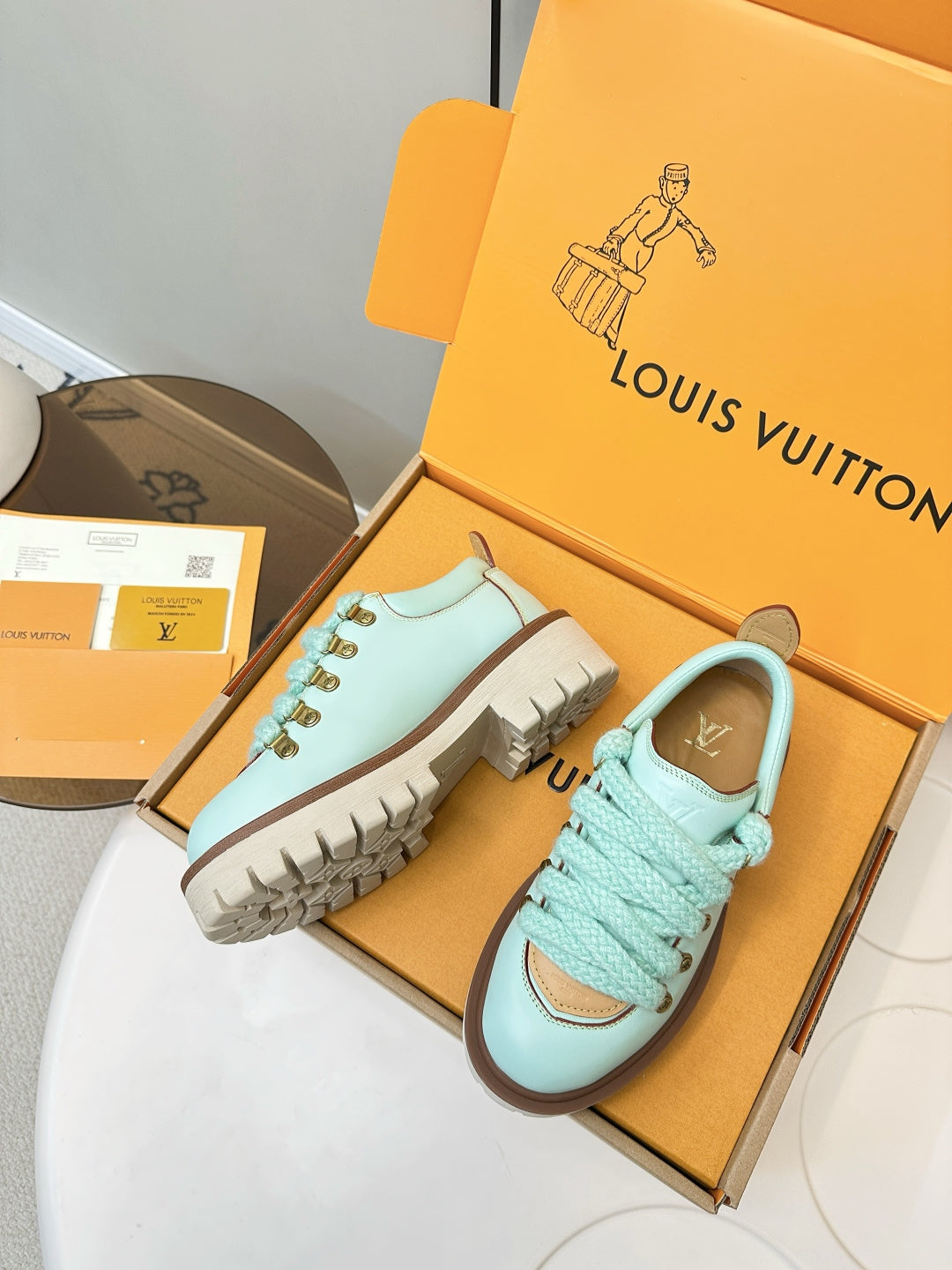Louis Vuitton light blue sneakers with gold lace eyelets and brown outsole tread