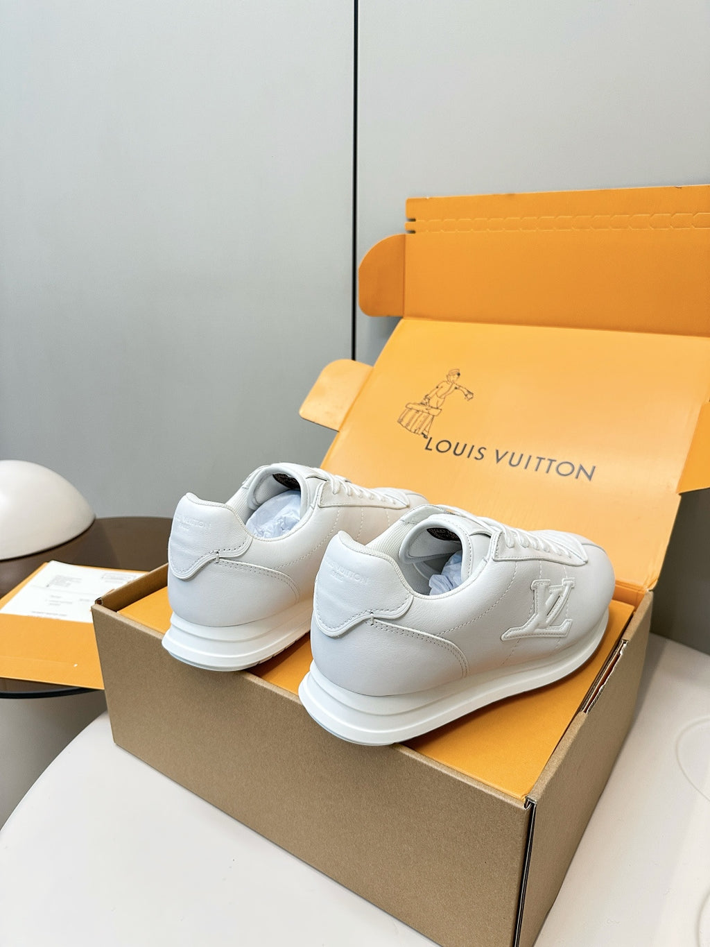 Louis Vuitton white sneakers pair, heel and rear view with lace-up tabs