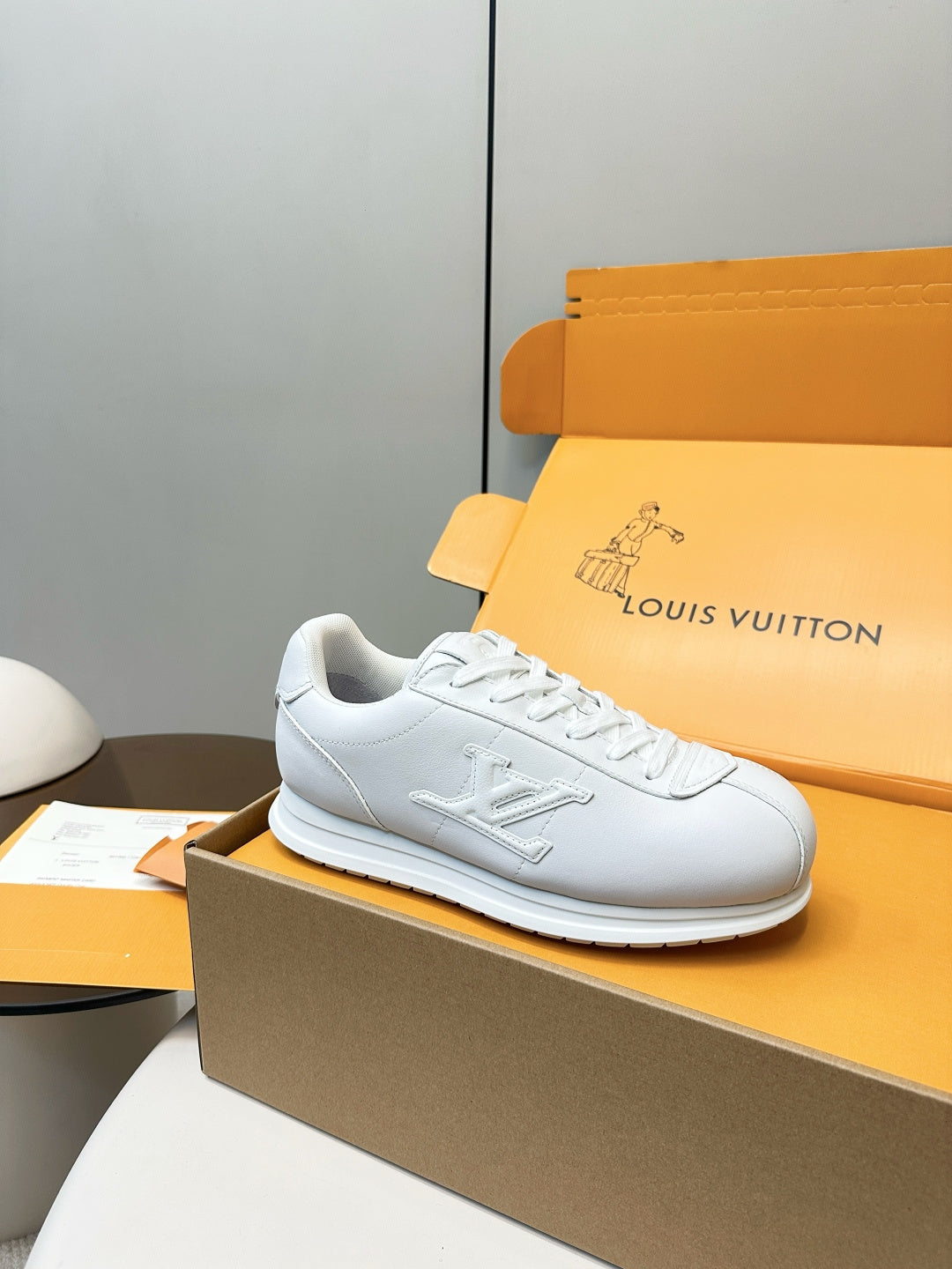 Louis Vuitton white sneaker on side, lace-up with textured sole