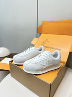 Louis Vuitton white sneakers pair, angled side profile with embossed logo