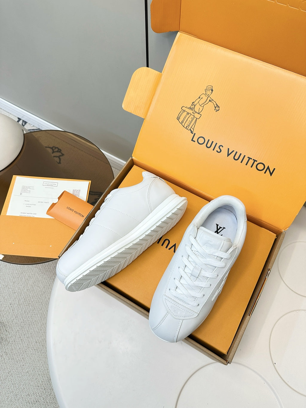 Louis Vuitton white sneakers pair, top view showing laces and low-profile sole