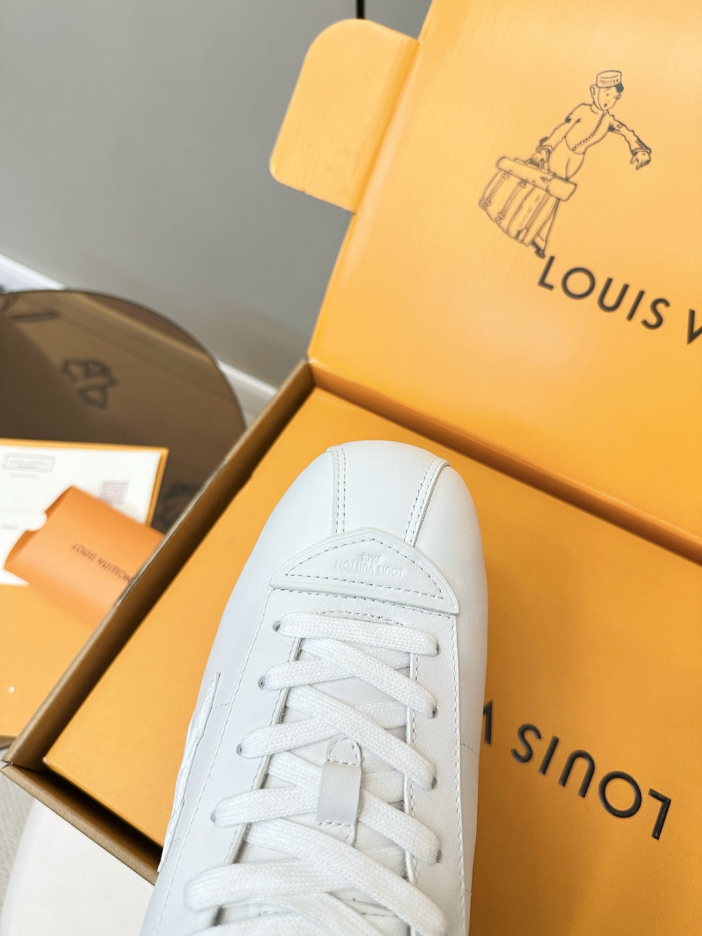 Louis Vuitton white sneaker close-up, laces and stitched toe cap