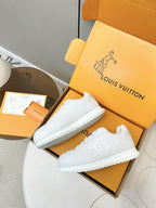 Louis Vuitton white sneakers pair, angled view with low-profile sole