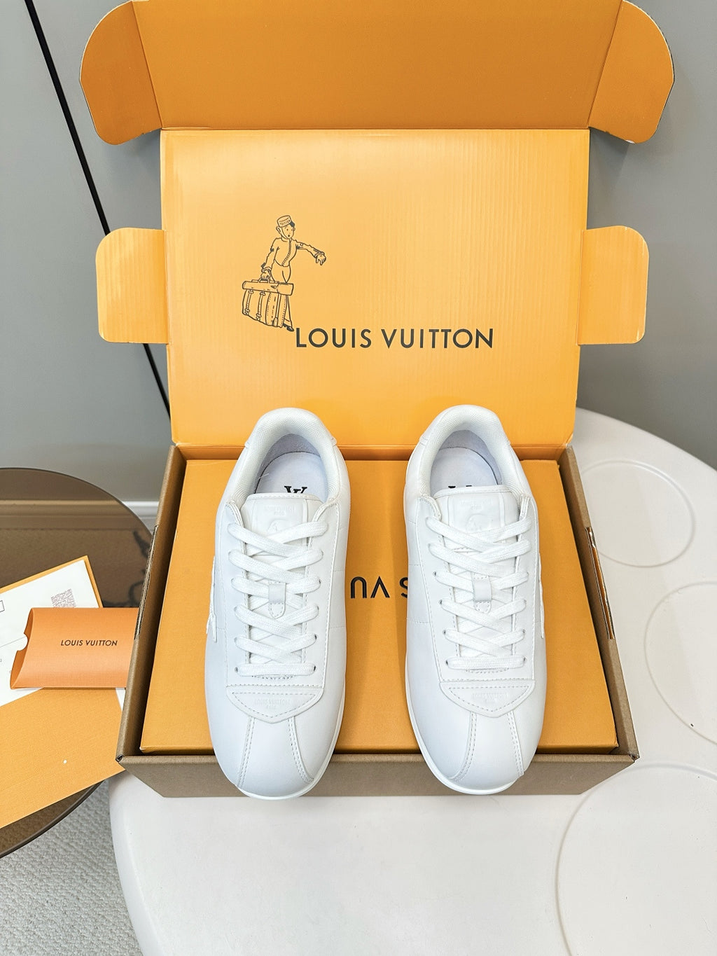 Louis Vuitton white sneakers, front view pair with lace-up design