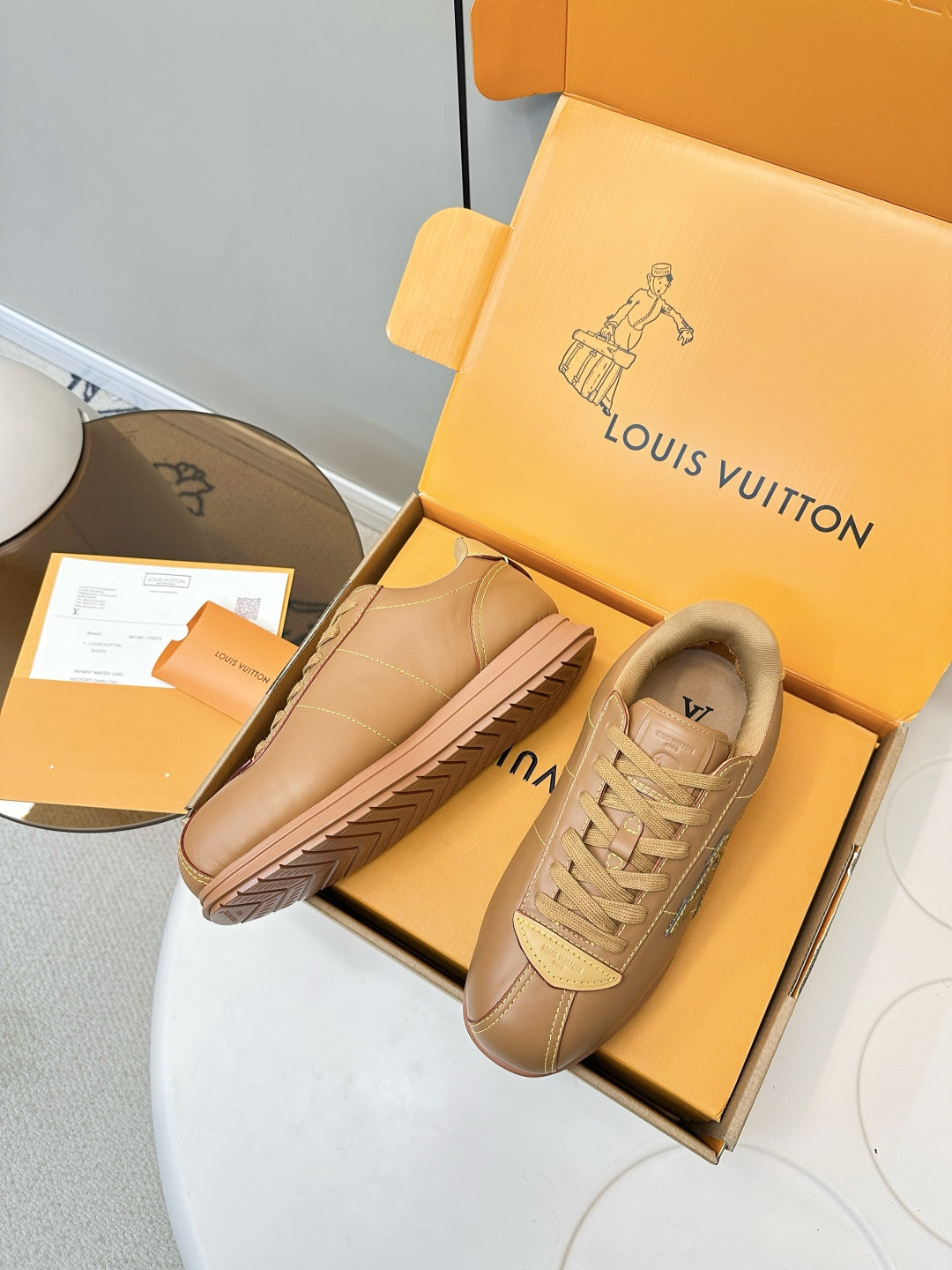 Tan lace-up sneakers with LV logo, side stripes and textured sole detail
