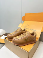 Tan lace-up low-top sneakers with LV side logo, seated on shoe box