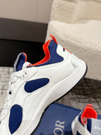 Unisex sneakers angled view: white uppers, navy panels, bright red collar lining, Dior