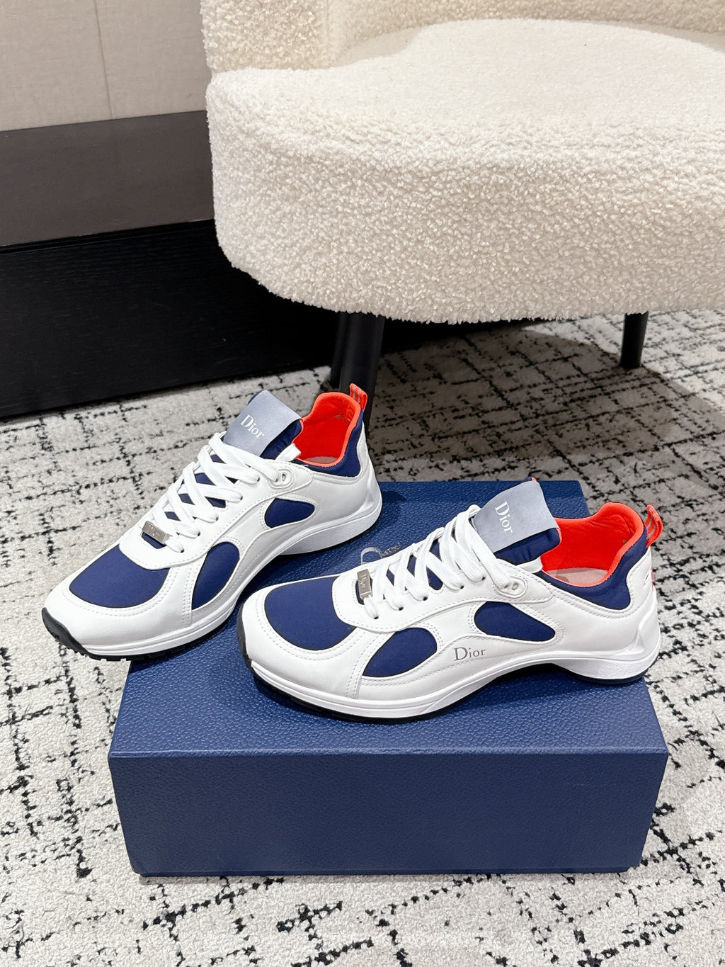 Pair of unisex low-top sneakers in white with navy panels and red collar lining, Dior