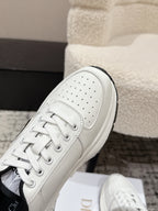 White leather sneaker upper with perforations and lace-up front close-up