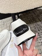 White sneaker with black tongue label reading 'Christian Dior Paris'