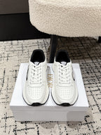White lace-up sneakers with black heel tab and Dior-style logo on side