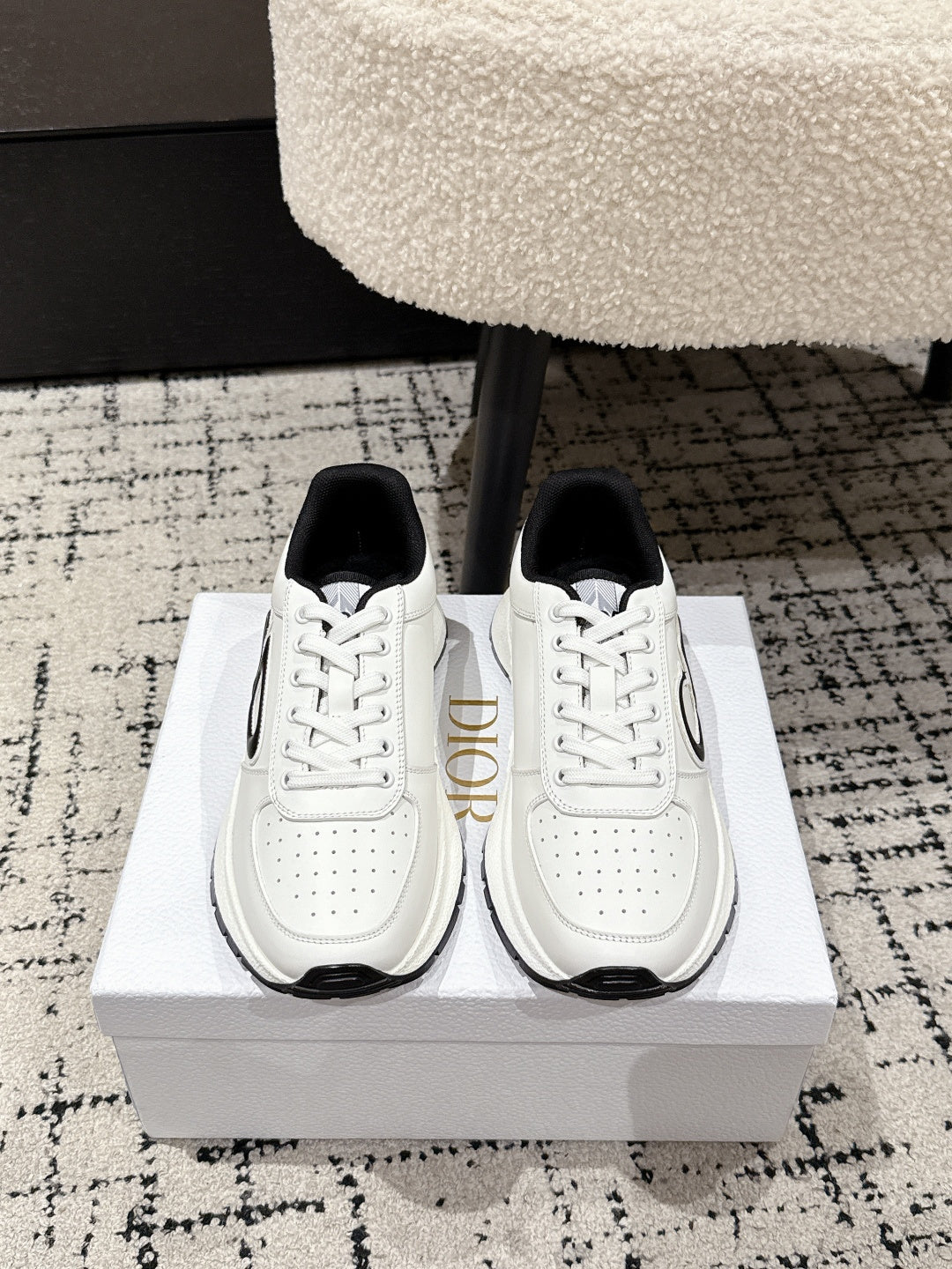White lace-up sneakers with black heel tab and Dior-style logo on side