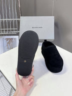 Balenciaga black suede slip-on sandals with textured rubber outsole close-up