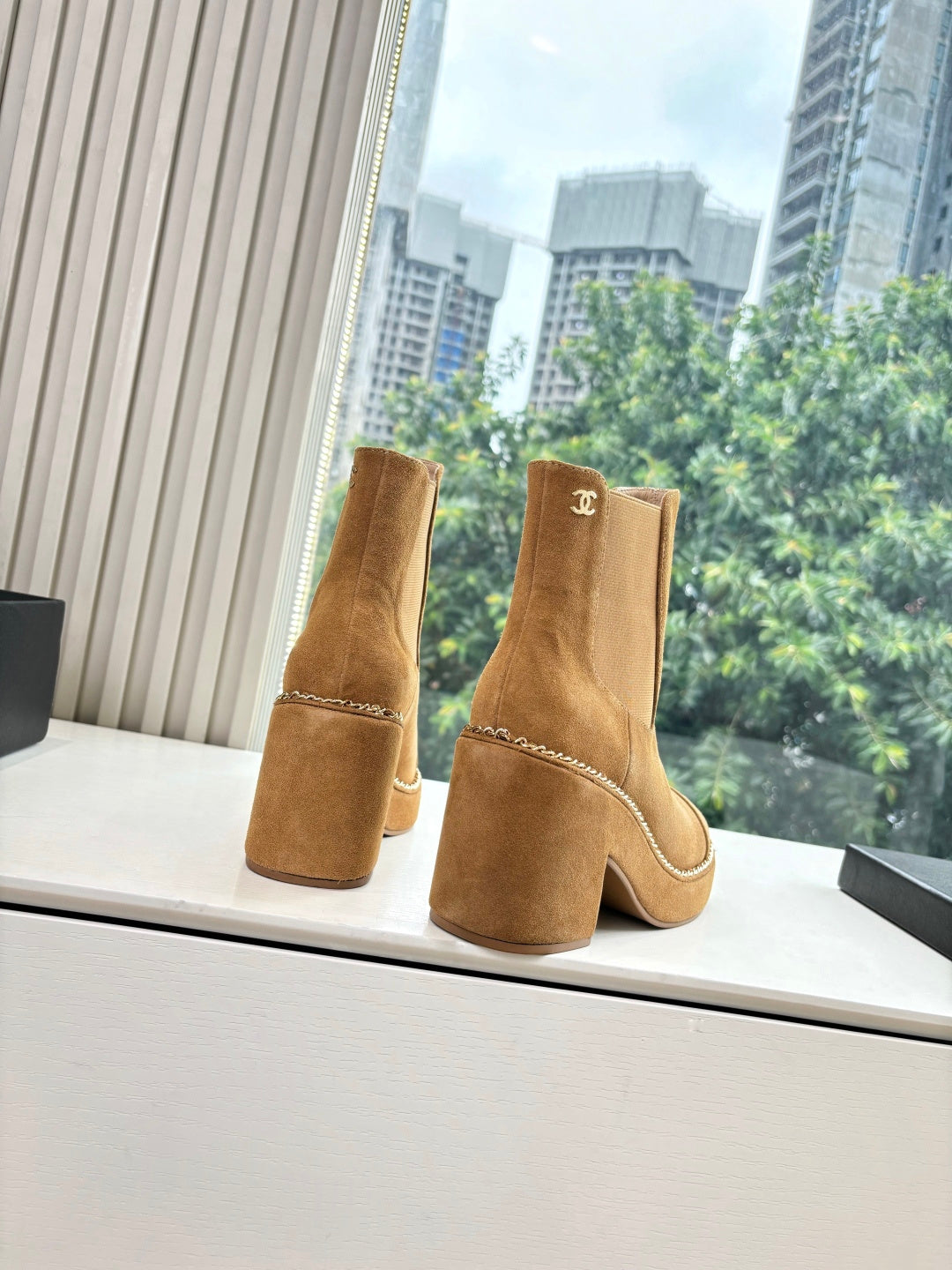 Chanel tan suede ankle boots with chain trim, side pull tabs, logo detail