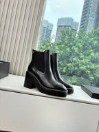 Black Chelsea ankle boots with square toe and stitched edging