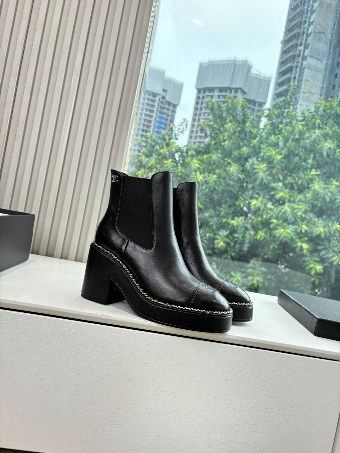 Black Chelsea ankle boots with square toe and stitched edging