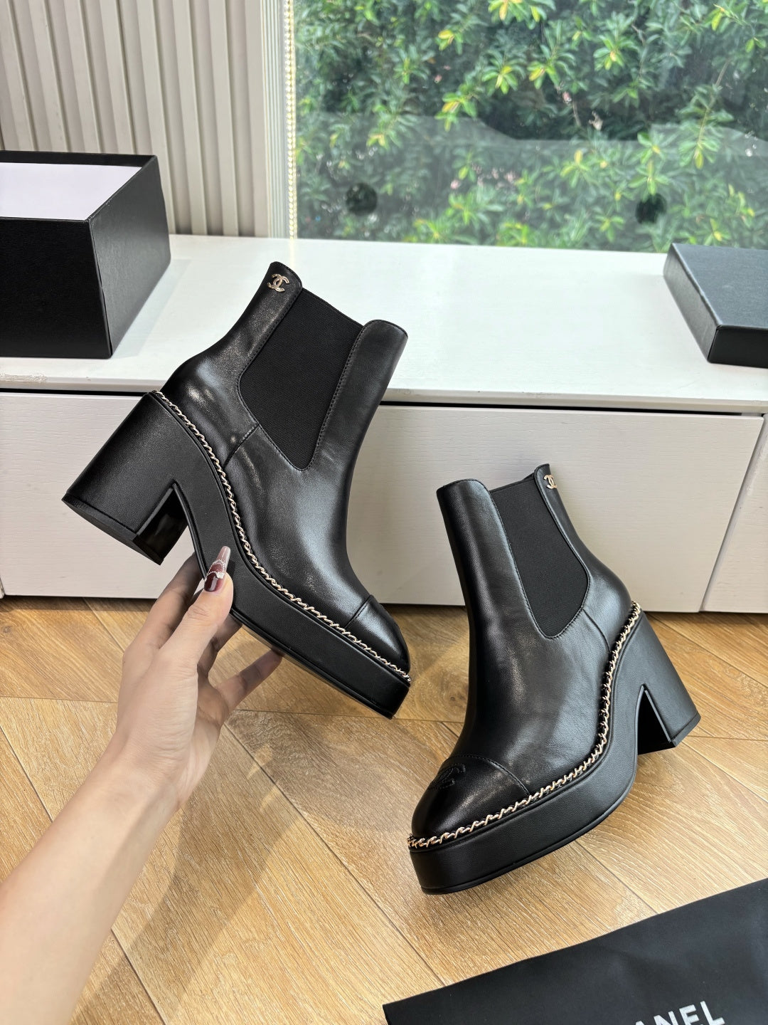 Black Chelsea ankle boots with block heels, side elastic, and small emblem