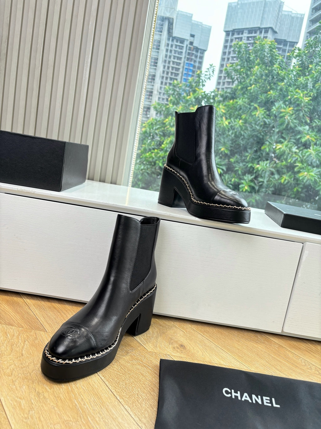 Pair of black ankle boots with block heels and contrast-stitched edging