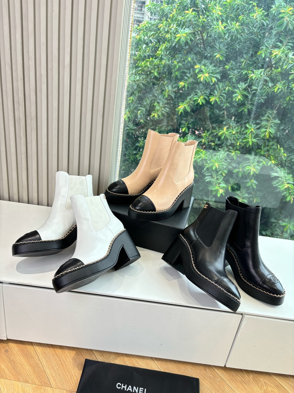 Women’s ankle boots in white with black block heel and elastic side panels