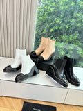 Women’s ankle boots in white with black block heel and elastic side panels