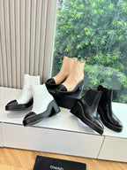 Women’s ankle boots in white with black block heel and elastic side panels