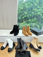 Women’s ankle boots display: white, black, and tan Chelsea styles with block heels