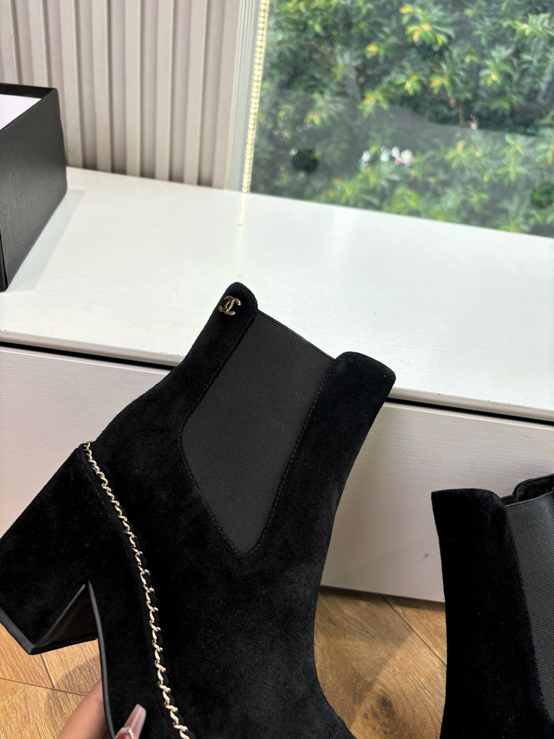 Black suede Chelsea-style ankle boot with elastic side panel and chain-stitch trim