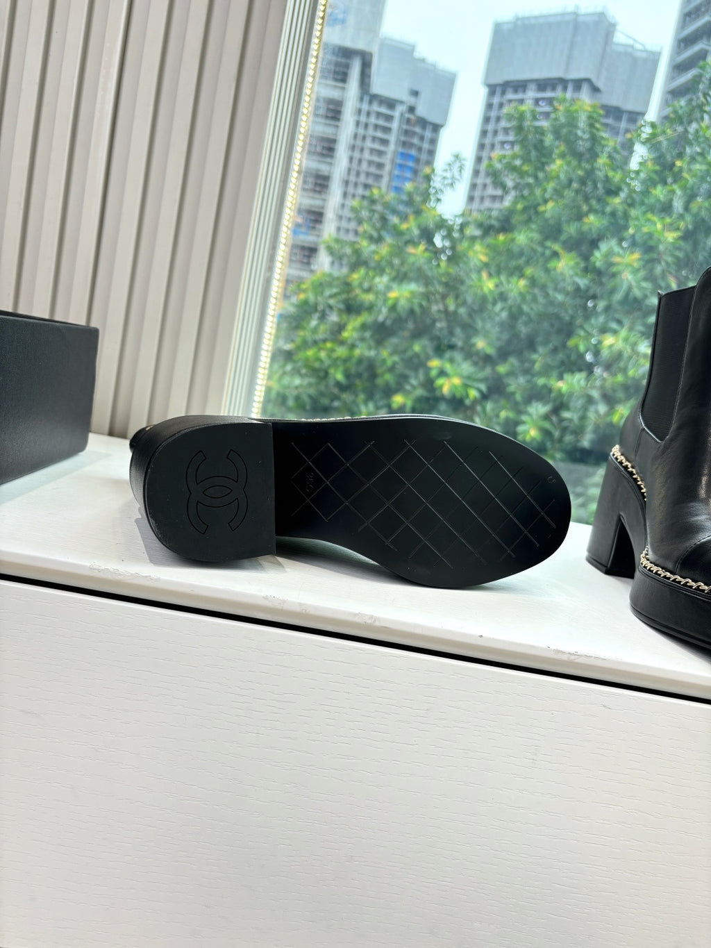 Black ankle boot outsole with tread pattern