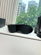 Black ankle boot outsole with tread pattern
