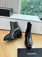 Black ankle boots with stacked block heels and contrast-stitched border
